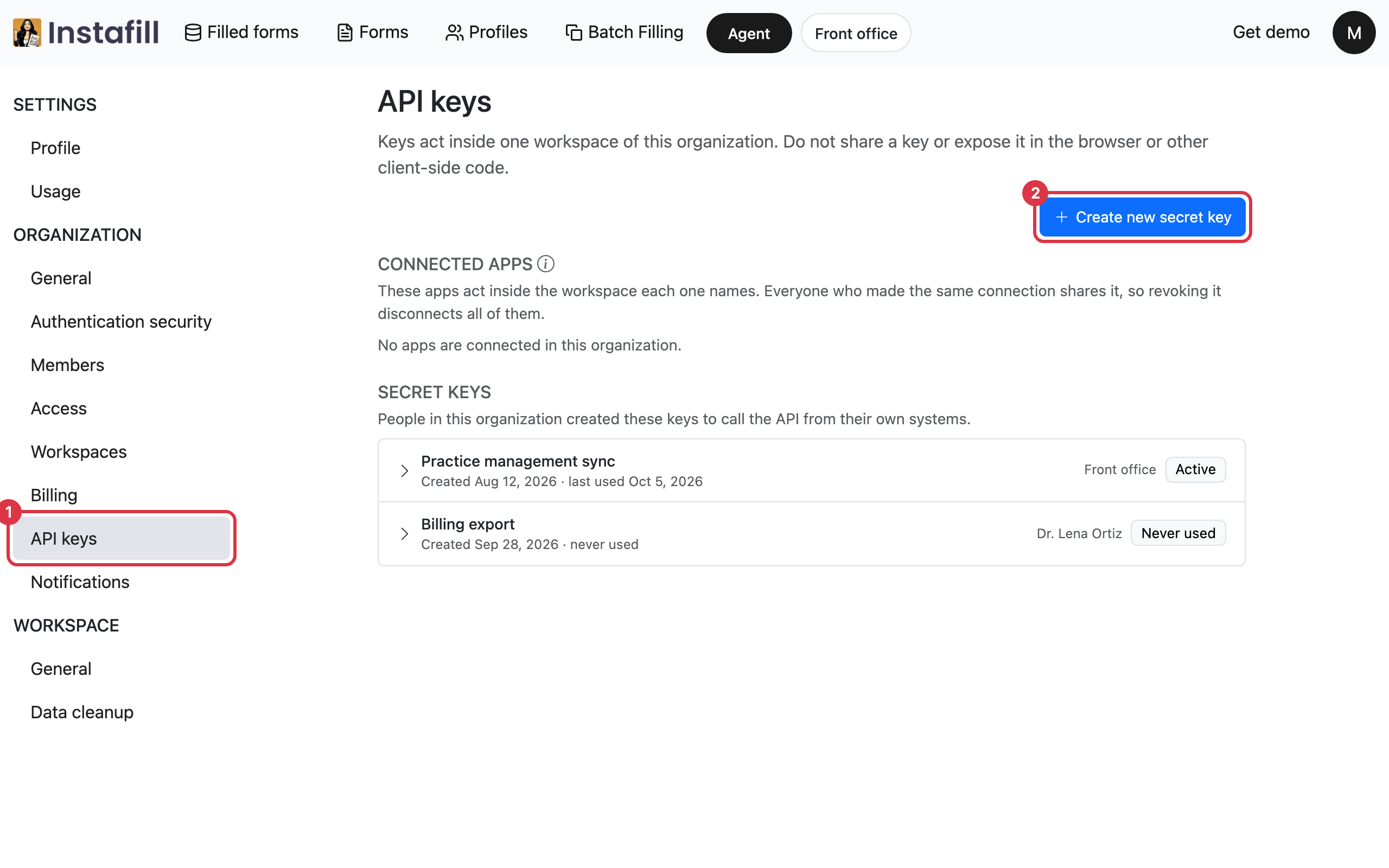 The API keys page listing two secret keys, each with its workspace and status, and the Create new secret key button